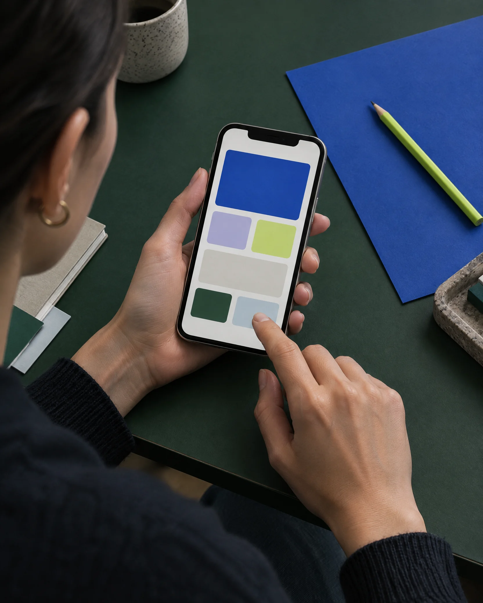 Person testing a mobile prototype on a work table